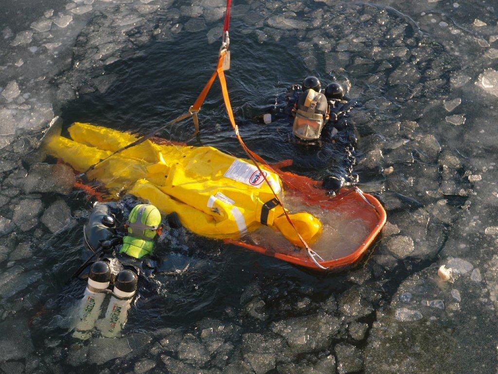 Dummy in wet suit being rescued