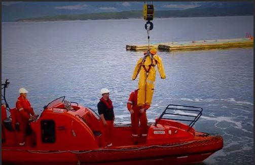 Manikin with wet suit being lifted out of water